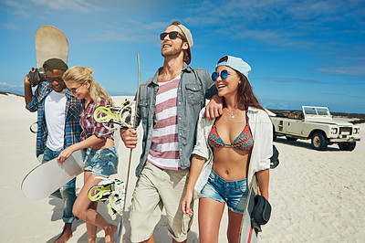 Buy stock photo Shot of a group of young friends going on a sand boarding road trip in the desert