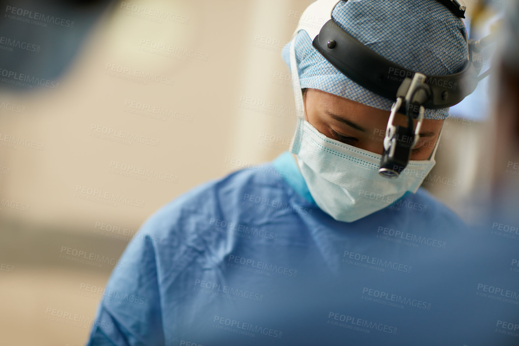 Buy stock photo Shot of a surgeon performing a surgery in an operating room