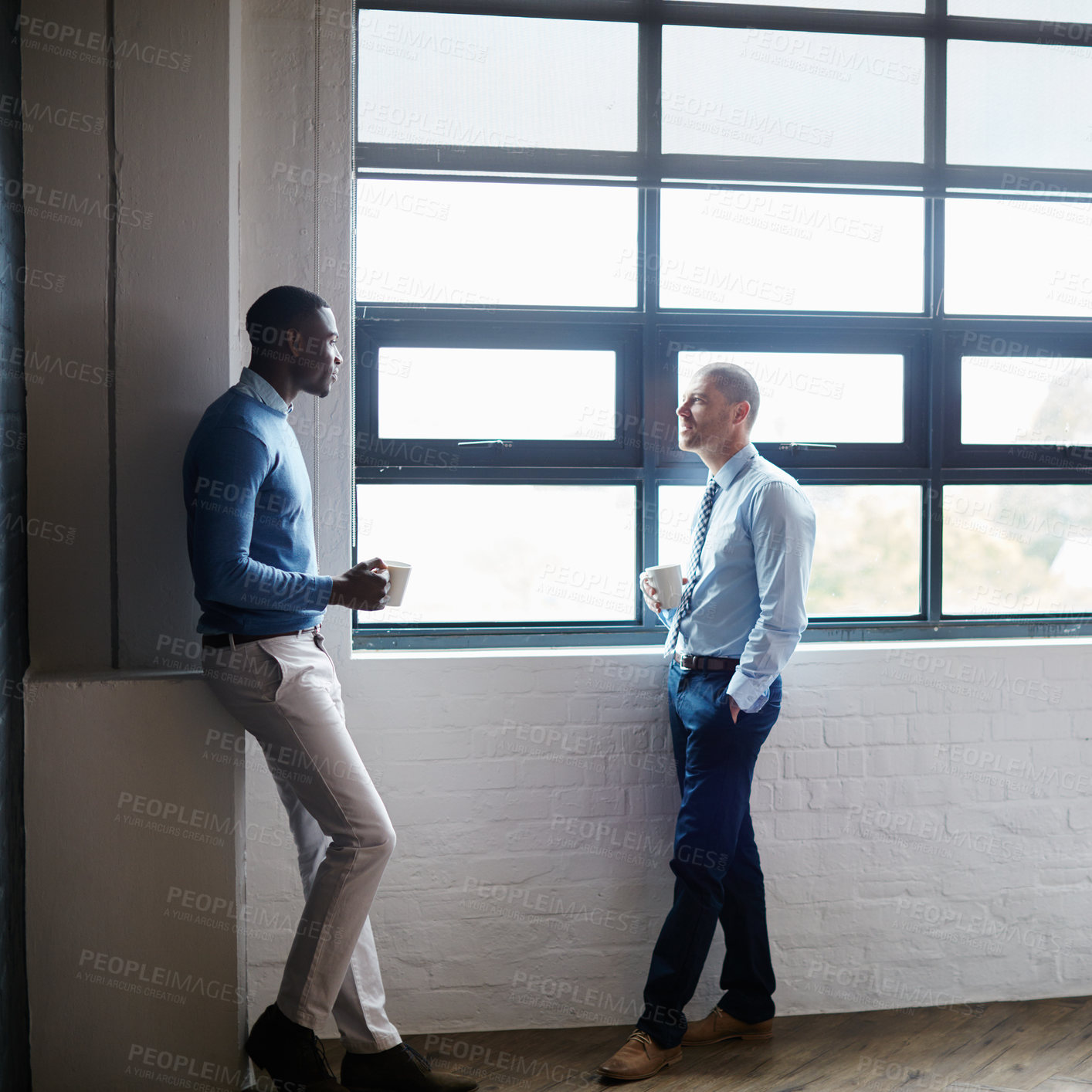 Buy stock photo Shot of two businessmen having a discussion in an office