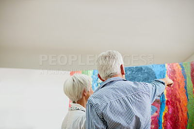 Buy stock photo Shot of a senior couple painting at home