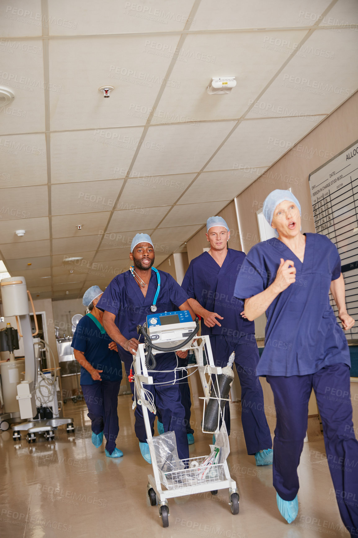 Buy stock photo Shot of a medical team rushing through a hospital corridor