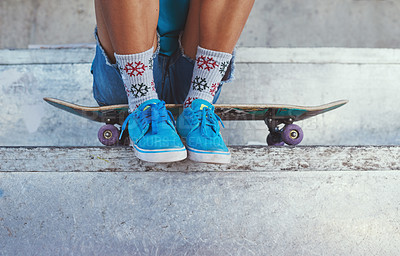 Buy stock photo Cropped of a young woman sitting on her skateboard