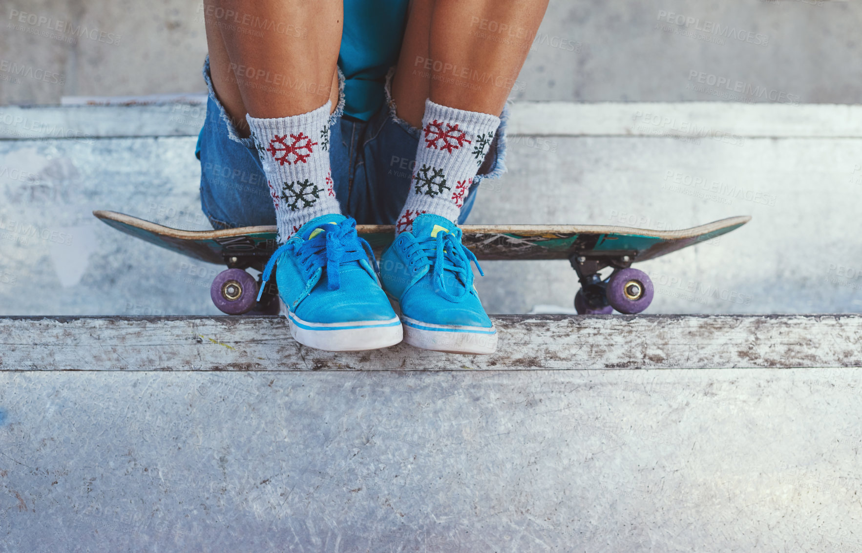 Buy stock photo Cropped of a young woman sitting on her skateboard