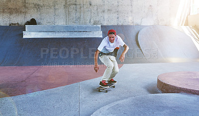 Buy stock photo Shot of a young man skating at a skatepark