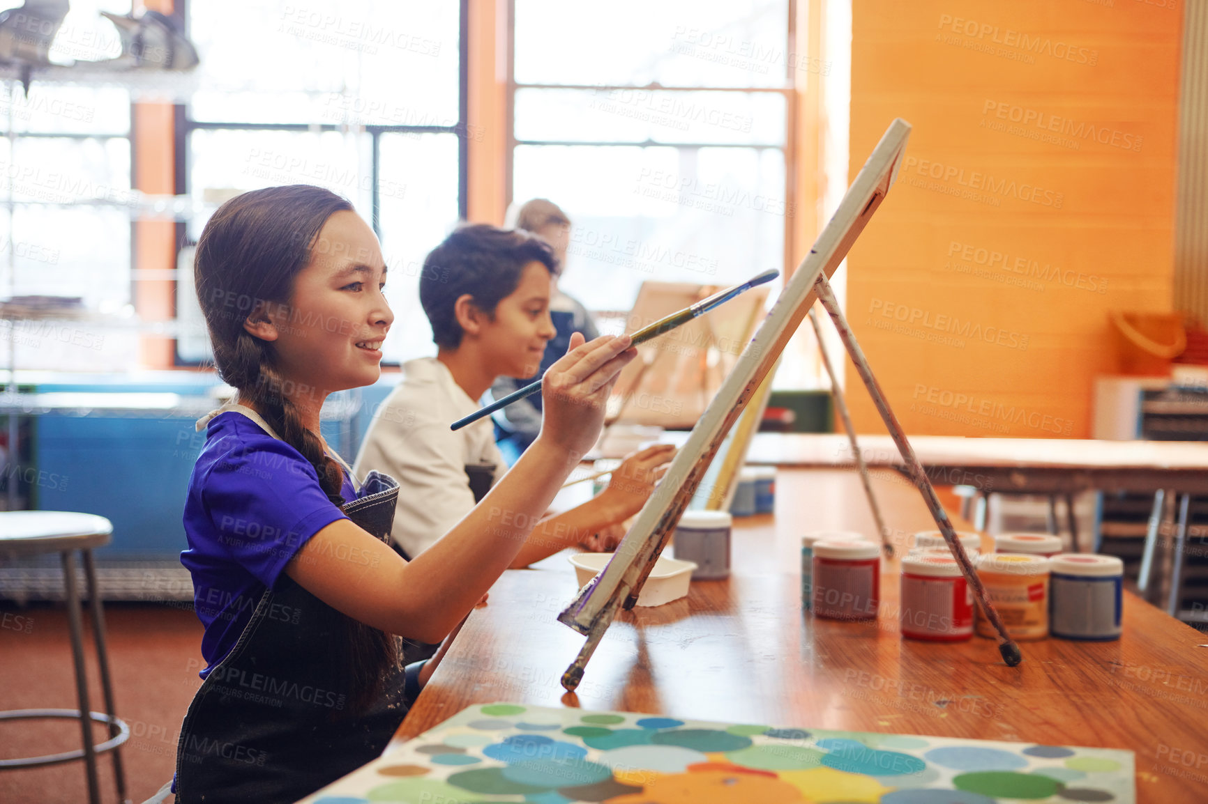 Buy stock photo Shot of a young schoolgirl in an art class