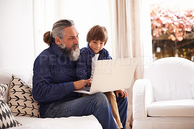 Buy stock photo Laptop, education or game with grandfather and child, growth and development in living room. Technology, elearning or grandpa on sofa in family home, streaming or online and internet with elderly man