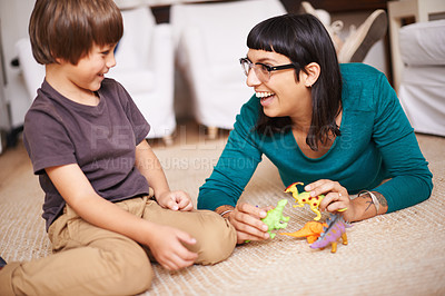 Buy stock photo Mother, kid and toy with dinosaur, floor and play for joy or fun at family home or house.  Woman, child and bedroom with bonding, childhood and future development or growth for happy care together