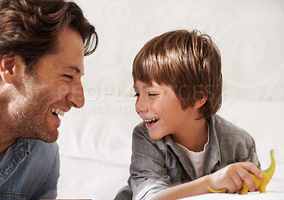 Buy stock photo Cropped shot of a happy father and son bonding at home