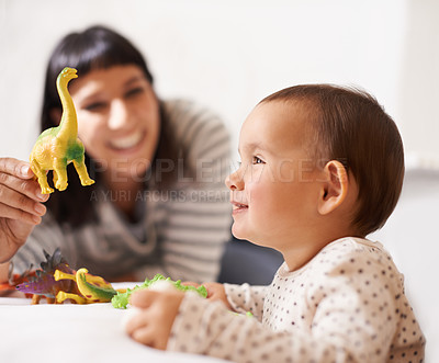 Buy stock photo Shot of a happy mother playing with her daughter and toys