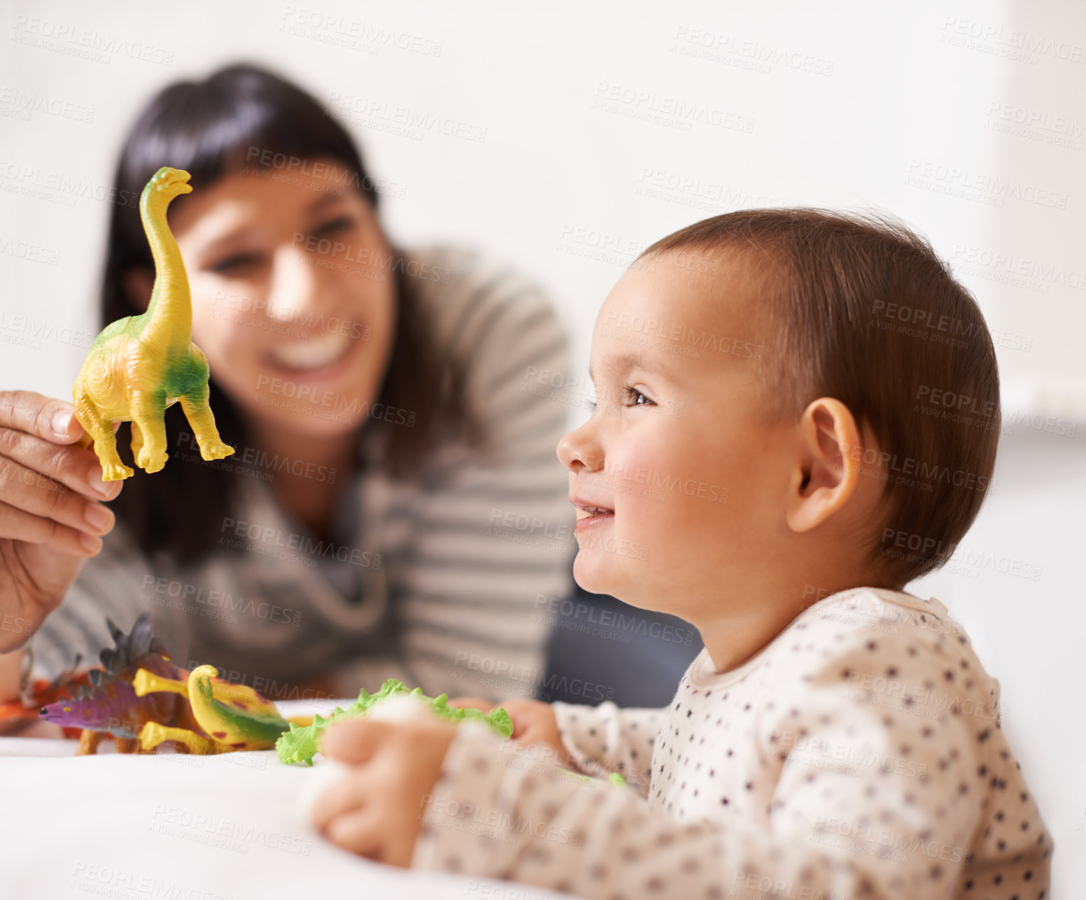 Buy stock photo Shot of a happy mother playing with her daughter and toys