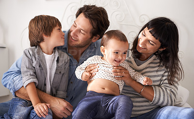 Buy stock photo Family, love and embrace with laugh in bedroom, support and happy for childhood in home on bed. Parents, children and security in connection or hug, care and relax on weekend or play for bonding