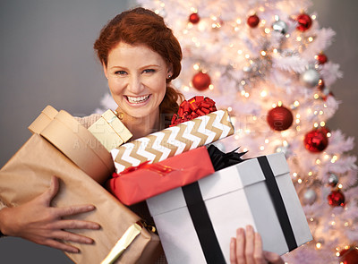 Buy stock photo Portrait of an attractive young woman holding her Christmas gifts