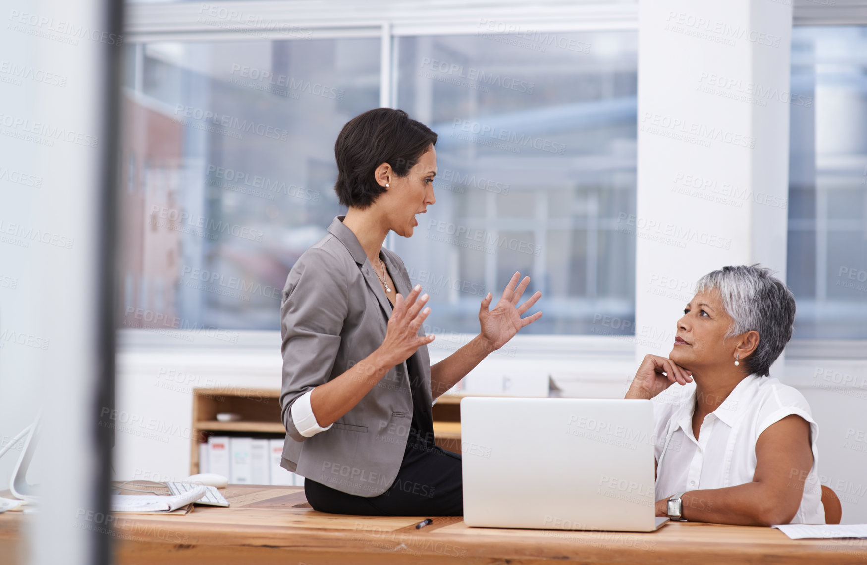 Buy stock photo Shot of two coworkers having a discussion in the office