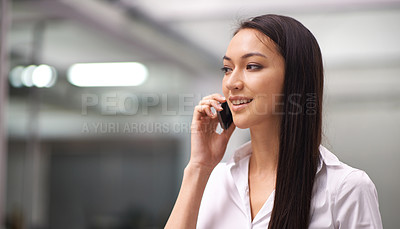 Buy stock photo Cropped shot of an attractive young woman using her cellphone in the office