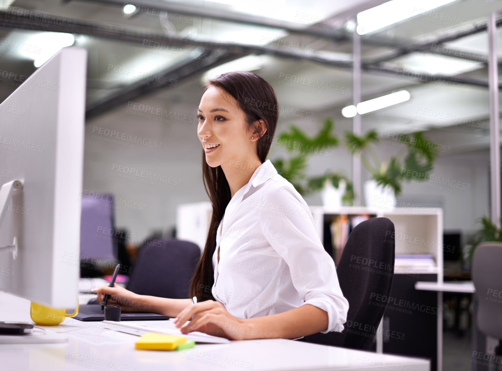 Buy stock photo Cropped shot of an attractive young woman working at her desk