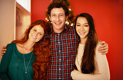 Buy stock photo Christmas, portrait and happy family in embrace, love and winter celebration by red background. Father, other and adult child and smile on face for holiday season, care and bonding together in home