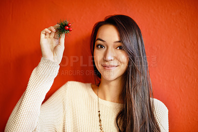 Buy stock photo Christmas, portrait and happy woman with holly branch in hand and winter celebration by red background. Young,  person and smile on face with holiday decoration, gift and symbol of peace or goodwill