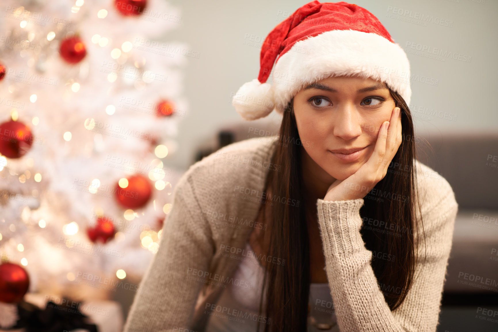 Buy stock photo Christmas, face and thinking with bored woman in living room of home for memory or nostalgia. Planning, idea or sad and lonely young person with Santa hat in apartment for December holiday season