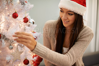 Buy stock photo Excited, christmas tree and woman decorating at her home for festive party, event or celebration. Happy, holidays and young female person with xmas ornaments for decoration at apartment or house.