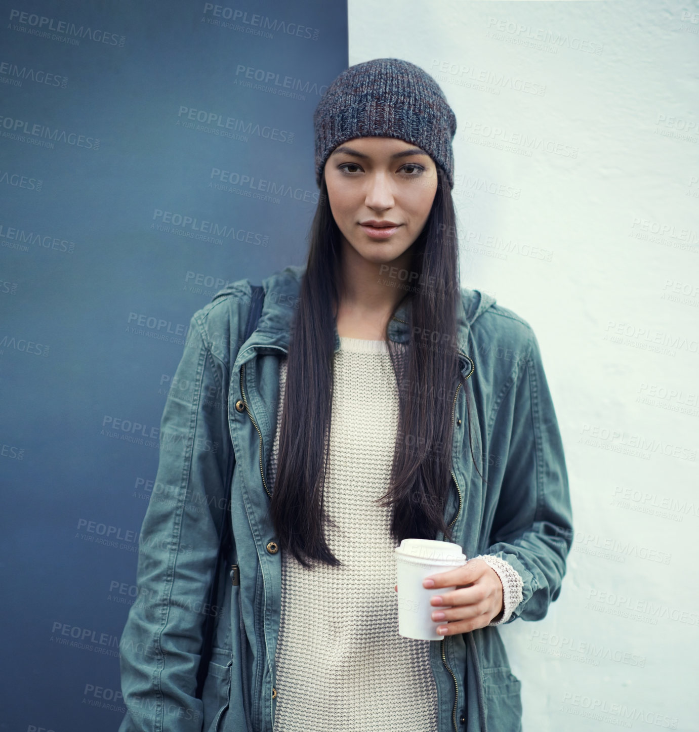 Buy stock photo Portrait of a woman with a cup of coffee by a wall with a casual, trendy and stylish outfit. Beautiful, gen z and young female person with takeaway warm beverage and cool fashion or style in the city