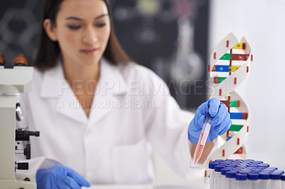 Buy stock photo Shot of a female scientist observing a sample in a test tube