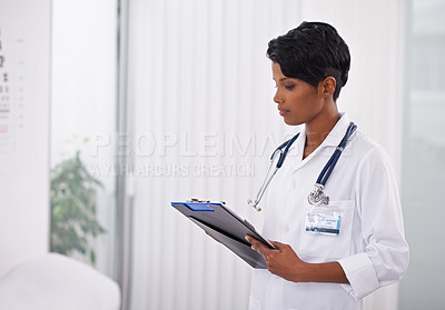 Buy stock photo Cropped shot young doctor writing on a patient's chart