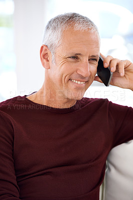 Buy stock photo Senior, happy man and phone call with communication on sofa for conversation or networking at home. Face of mature male person with smile, talking or mobile smartphone for online discussion at house