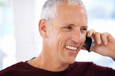 Buy stock photo Senior, man and happy with phone call in home for communication, discussion and mobile chat on weekend. Elderly, person and smile with smartphone for talking, retirement and networking in living room