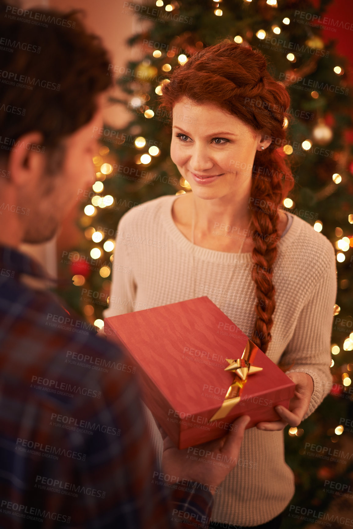 Buy stock photo Couple, Christmas and gift for holiday celebration, festive and season of giving for love and commitment. Happy, gratitude and support with people at home for present, romance and relationship