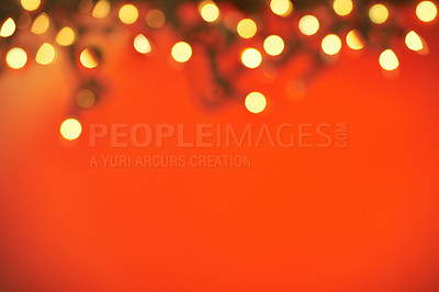 Buy stock photo Closeup shot of a string of Christmas lights on a red background with festive copyspace. Fairy light on a Christmas  festive blurred bokeh abstract background, in celebration and festive cheer 
