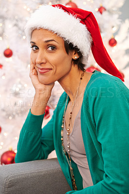 Buy stock photo Smile, santa hat and portrait of woman at her home for christmas event, party or celebration. Happy, holidays and face of female person from Colombia with festive xmas tree on sofa in apartment.
