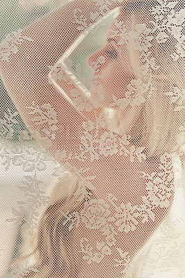 Buy stock photo Shot of a beautiful young woman behind a lacy curtain
