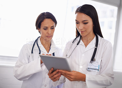 Buy stock photo Hospital, women or doctors with tablet, advice and checking results online for healthcare in lobby. Consulting, research and professional medical team on digital app for schedule, planning in clinic