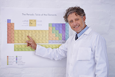 Buy stock photo Laboratory, periodic table and portrait of scientist with research, teaching and smile in classroom. Science, education and professor man pointing at chemical elements on poster at lecture for study