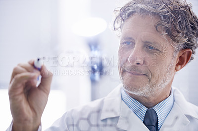 Buy stock photo A cropped shot of a mature scientist writing out molecular formulas in his lab