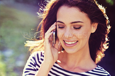 Buy stock photo Woman, happy and phone call with talking outdoor for conversation, networking and mobile chat with sunlight. Person, smile and smartphone in nature for communication, discussion or listening in wind