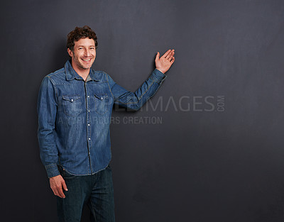 Buy stock photo Studio portrait of a handsome man presenting copyspace