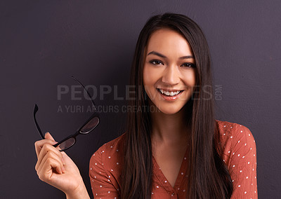 Buy stock photo Woman, portrait and glasses in studio for eye care prescription with confident smile, grey background or mockup space. Female person, vision and frame for healthy optometry, eye care or spectacles