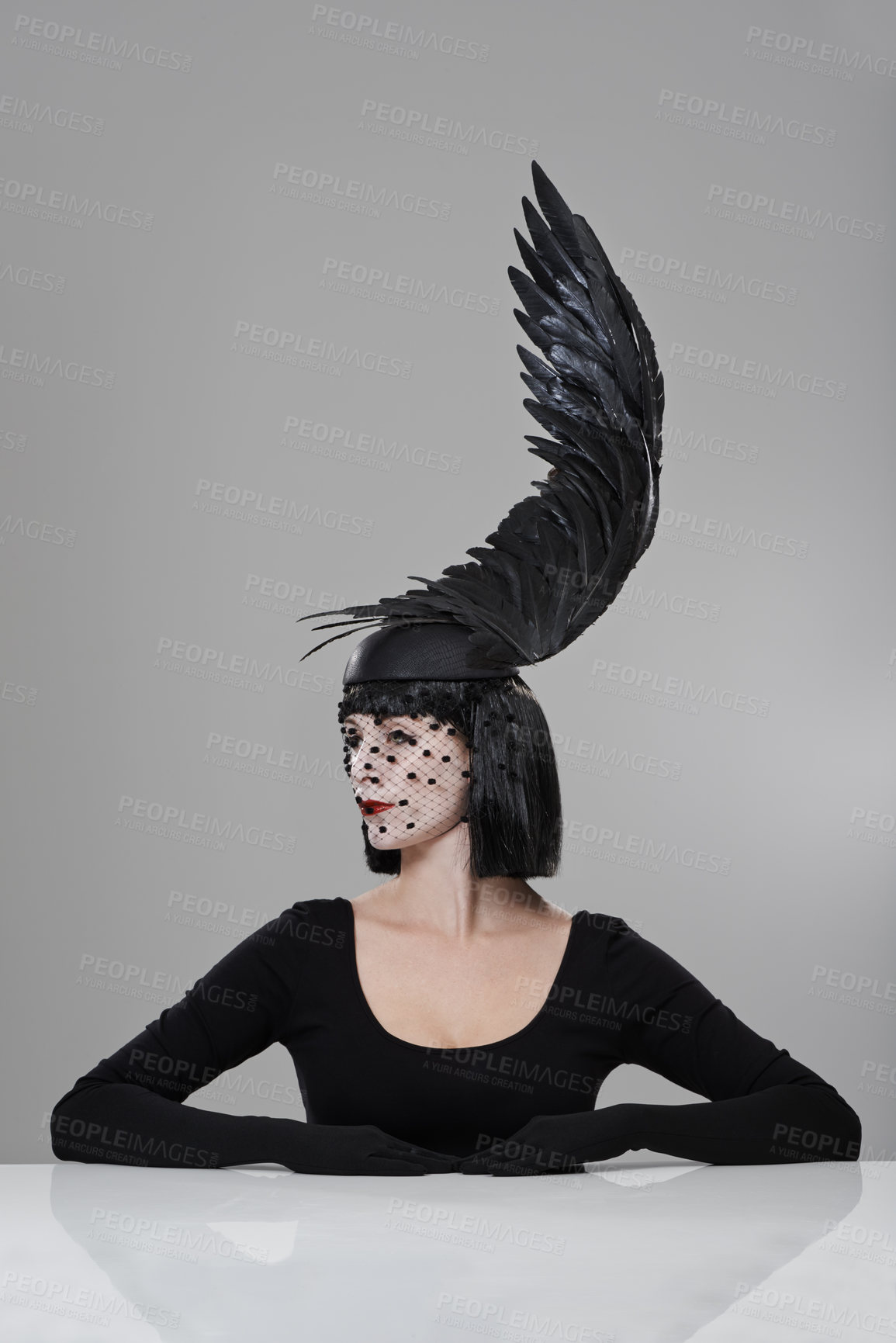 Buy stock photo Fashion, woman and feather cap in studio with thinking for glamour, style with confidence. Female person, birdcage veil and cap with wing for elegance, designer clothes and luxury on gray background