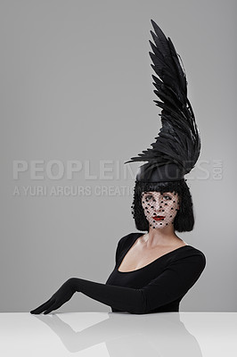 Buy stock photo Woman, portrait and feather for fashion in studio for fantasy or magic with unique creativity for art or illusion. Female person, isolated and white background for designer clothes, diva and surreal.