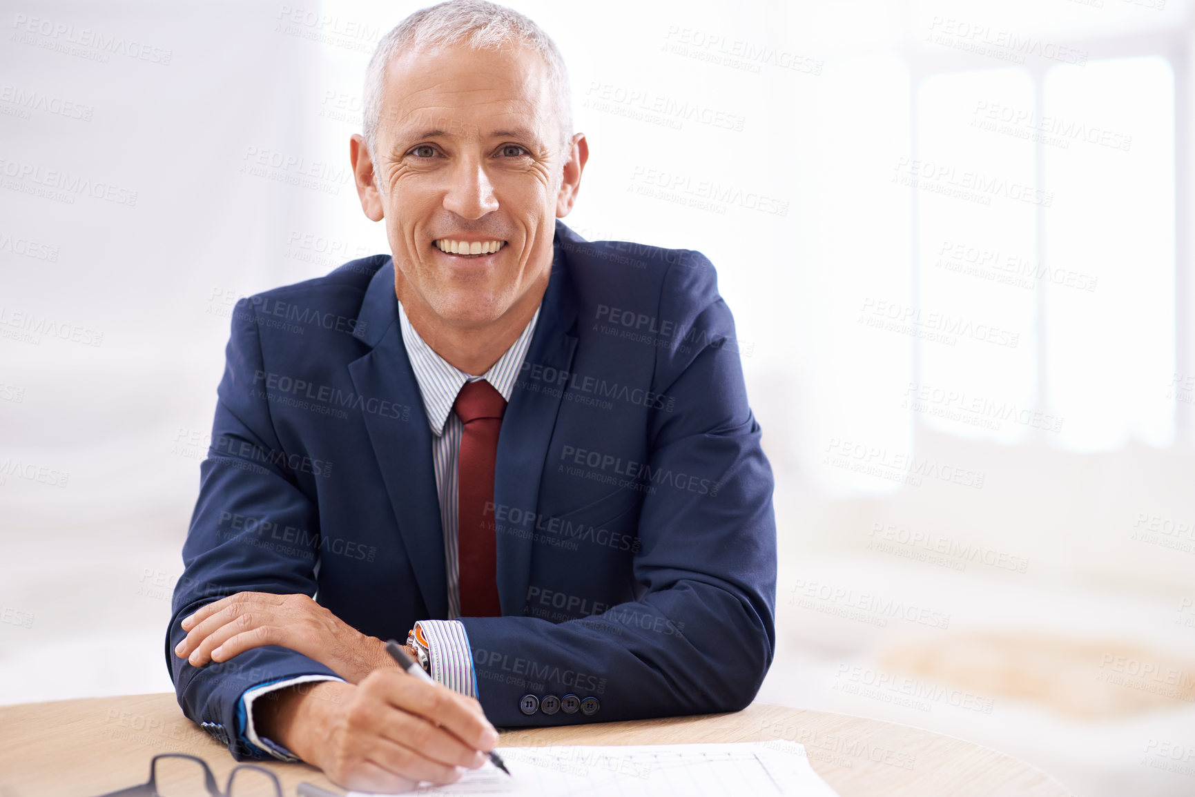 Buy stock photo Office, writing and portrait of senior businessman with confidence for career, job and working at desk. Professional, startup agency and person with notebook for company pride, smile and planning
