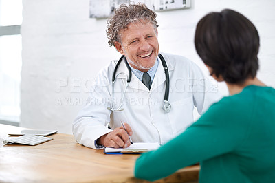 Buy stock photo Shot of a smiling mature doctor having a consultation with a patient