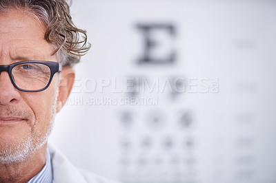 Buy stock photo Portrait of a mature optometrist standing in front of an eye chart