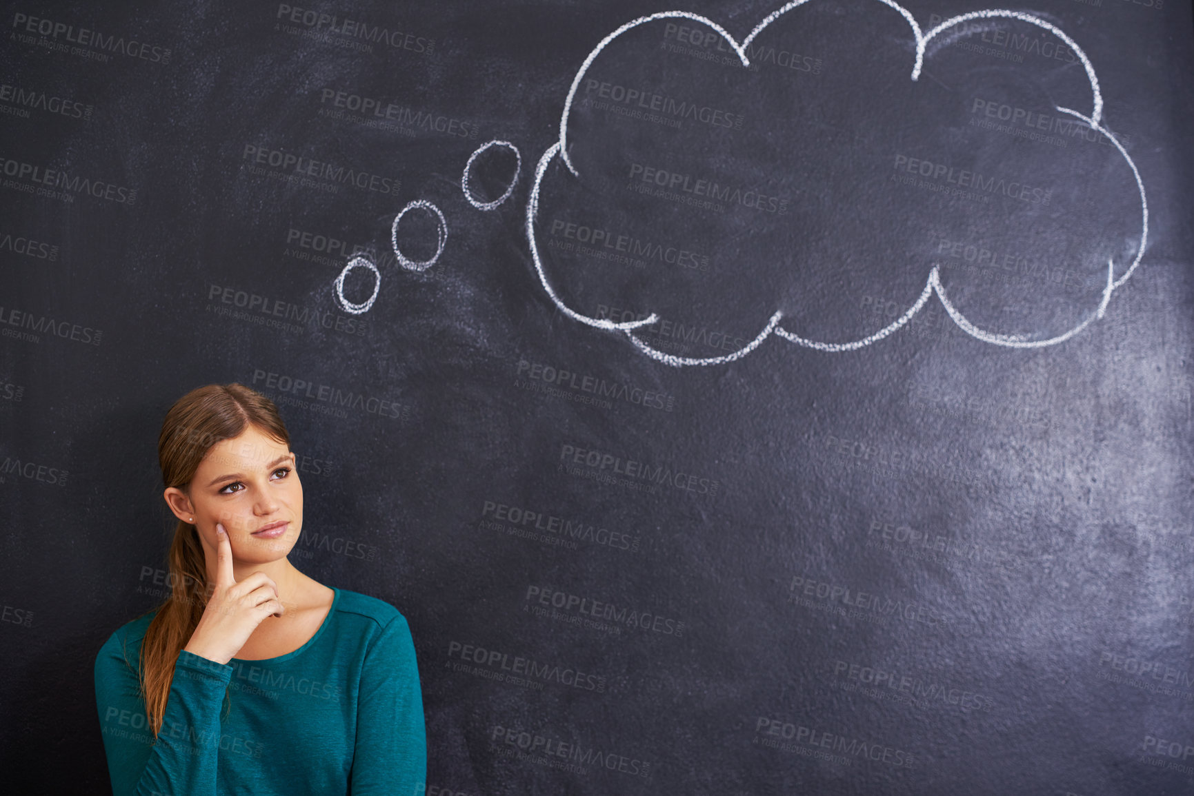 Buy stock photo Cropped shot of an attractive young woman standing in front of a blackboard