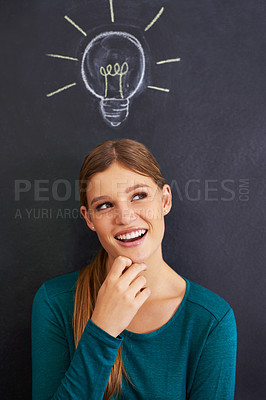 Buy stock photo Cropped shot of an attractive young woman standing in front of a blackboard