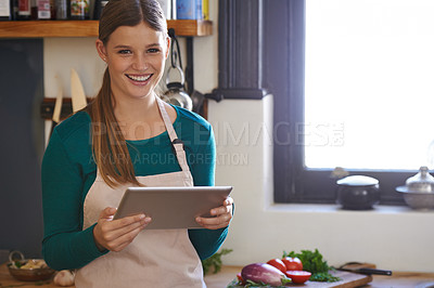 Buy stock photo Portrait of a young woman looking for online recipes on her digital tablet