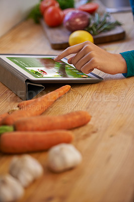 Buy stock photo Hand, cooking and tablet with vegetables in kitchen as nutrition meal or online recipe, diet or connectivity. Person, home and raw ingredients with internet or vegan eating or prepare, dinner or chef