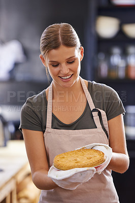 Buy stock photo Happy, woman and pie in kitchen at bakery with chef in restaurant cooking a lunch. Person, smile and food in hands of baker with pride and confidence in skill of baking pastry dish for dinner 