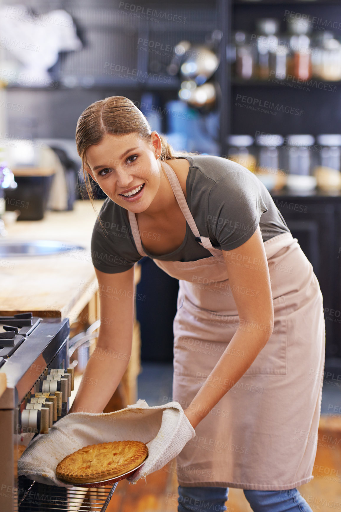 Buy stock photo Bakery, oven and woman in kitchen with a pie in portrait cooking as chef at restaurant or hotel. Person, smile and baker with food in catering business and baking dinner or lunch dish with skill