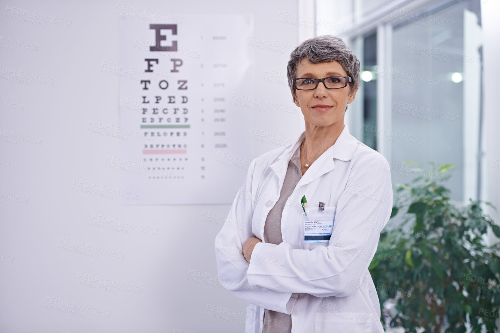 Buy stock photo Letter, chart and woman with optometrist for eye exam, arms crossed with confidence and senior doctor at clinic. Alphabet, glasses for vision and prescription lens with assessment and ophthalmology